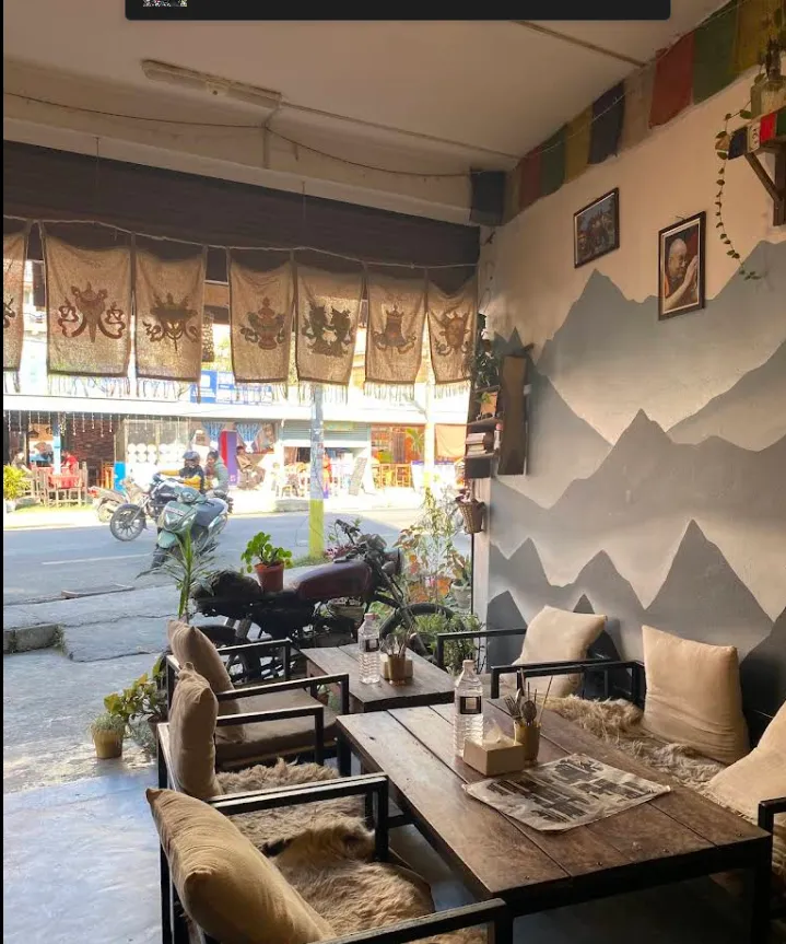 Window seating with cushions, prayer flags and a view onto Lakeside Street.