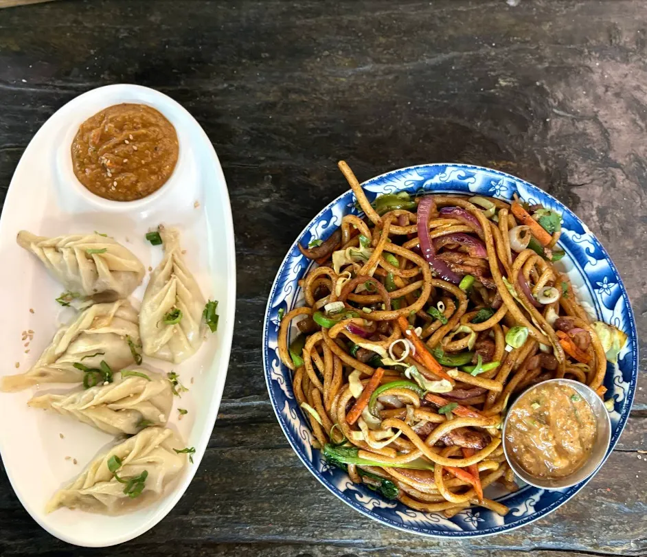 Sherpa chowmein noodles with a side of steamed momo.