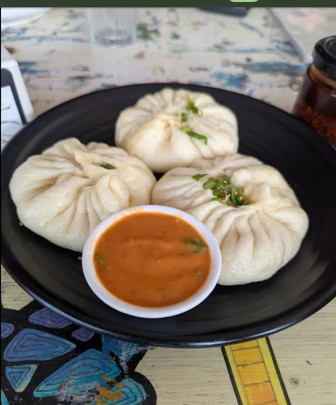 A plate of freshly steamed Sherpa momo with house tomato achar.