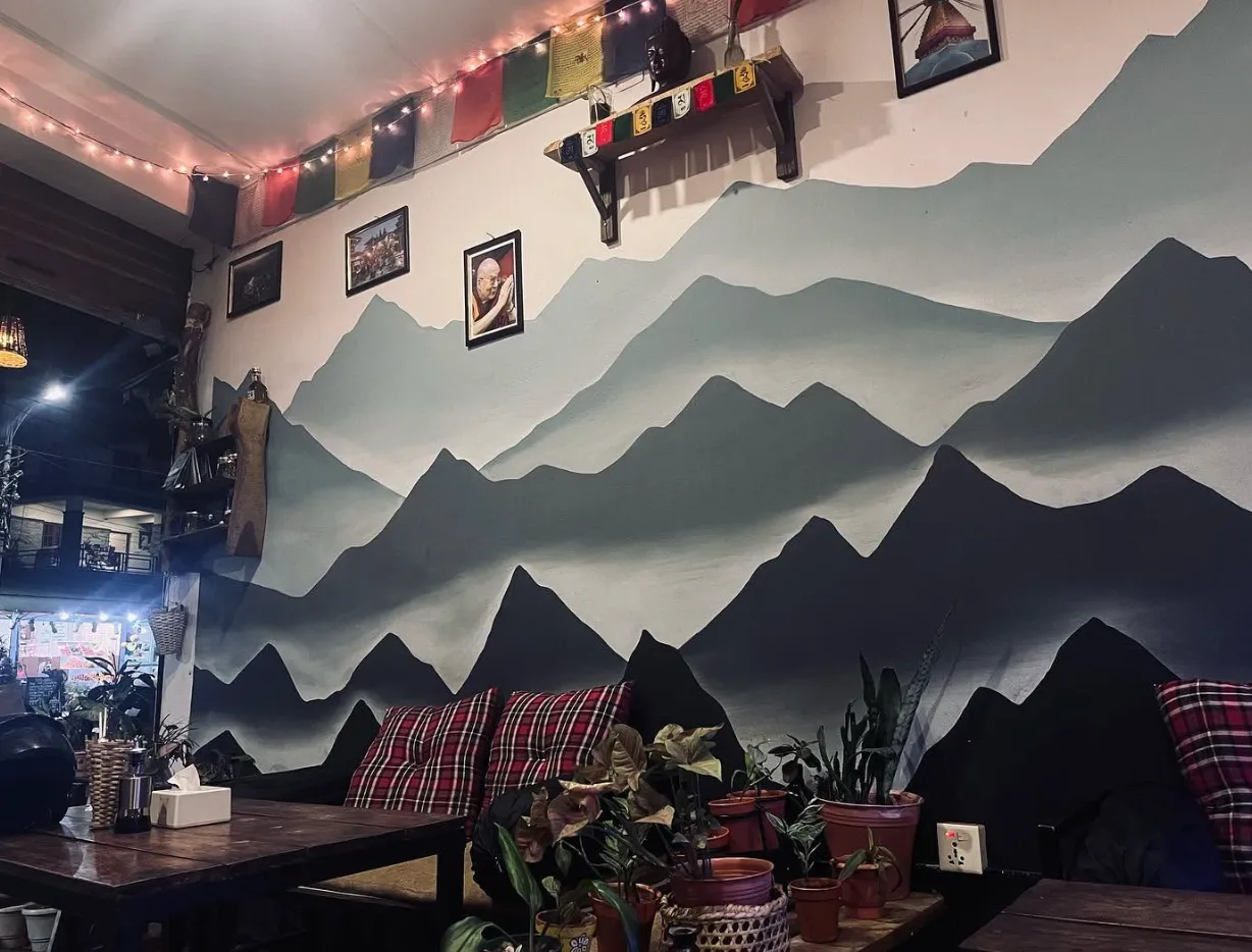The hand-painted Himalayan mountain mural and prayer flags inside the restaurant.