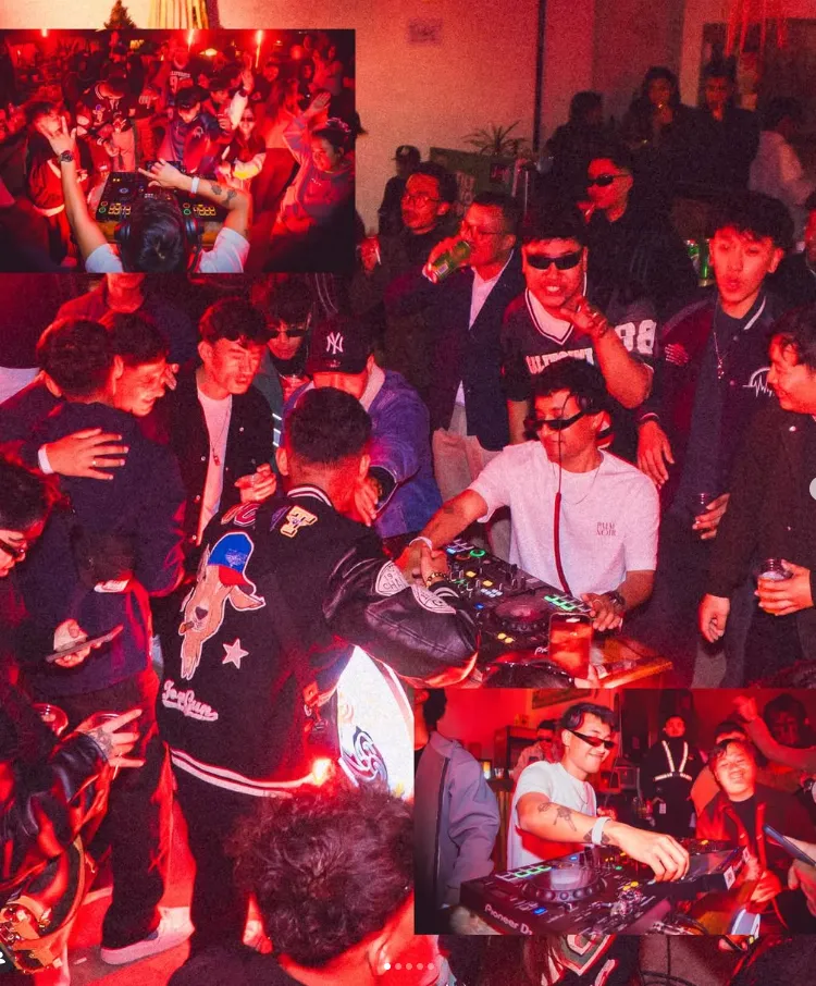 A packed late-night party at the Sherpa bar lit in deep red.